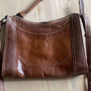 Brown Frye leather purse with adjustable strap.